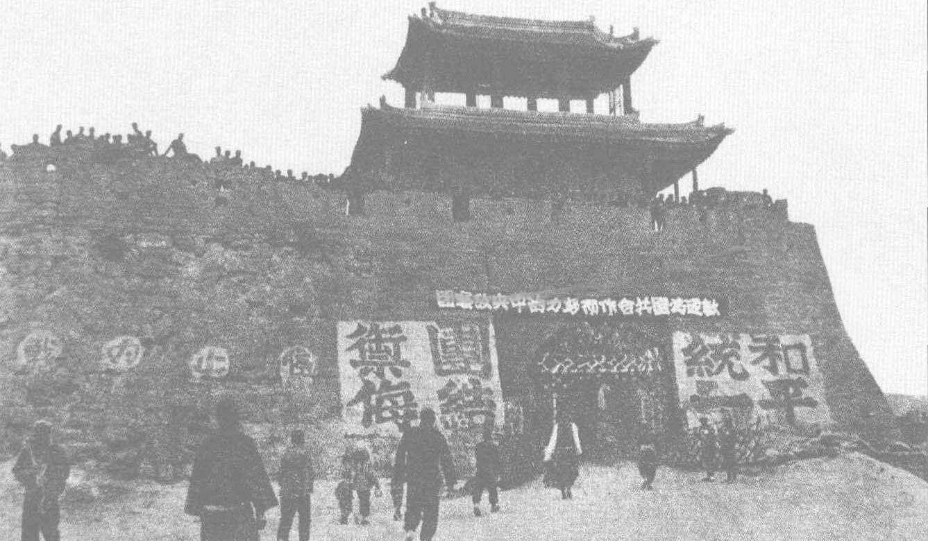 延安城南门悬挂着欢迎国民党中央考察团的大标语，城楼上站满了欢迎的人群